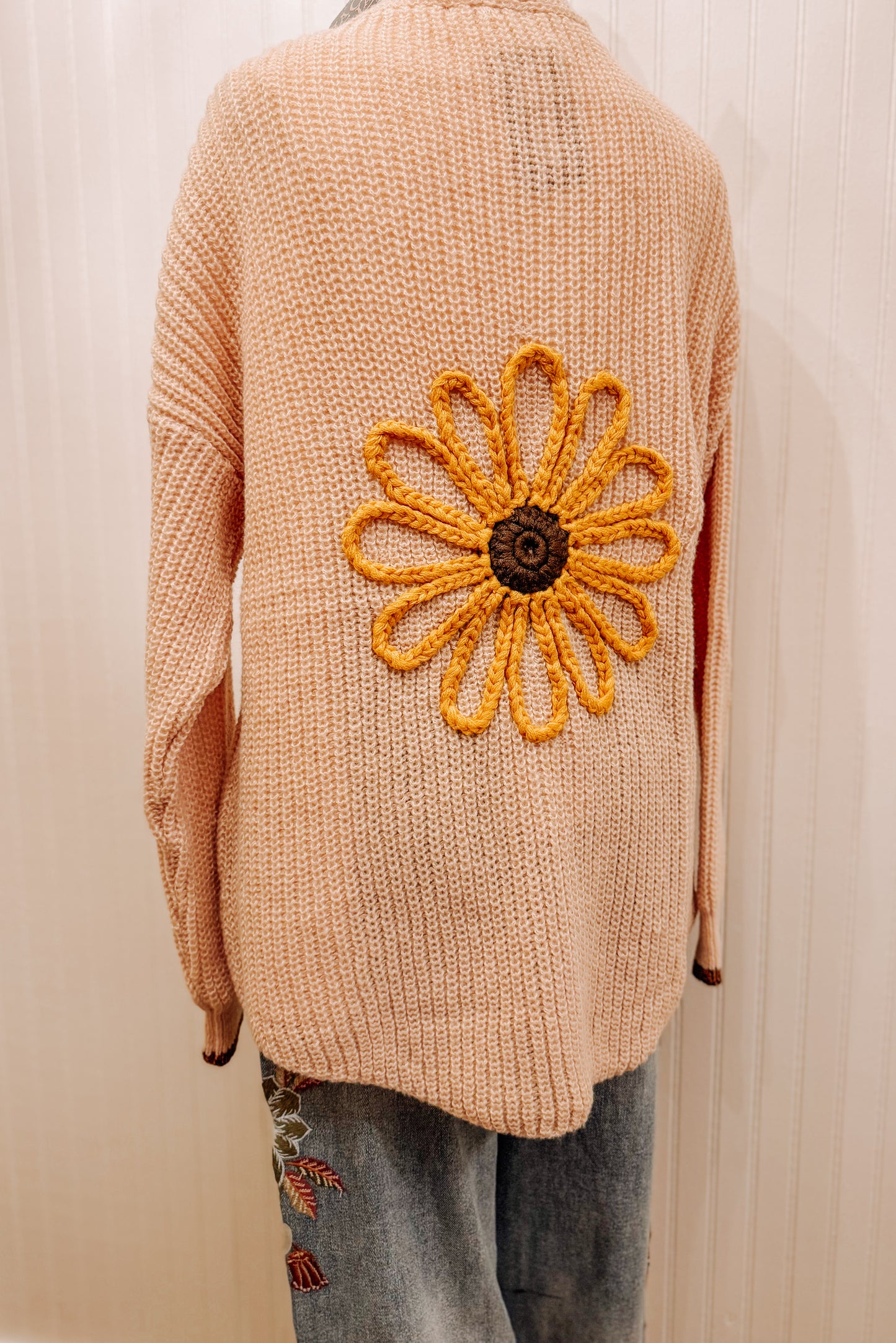 Peach knit sunflower cardigan.