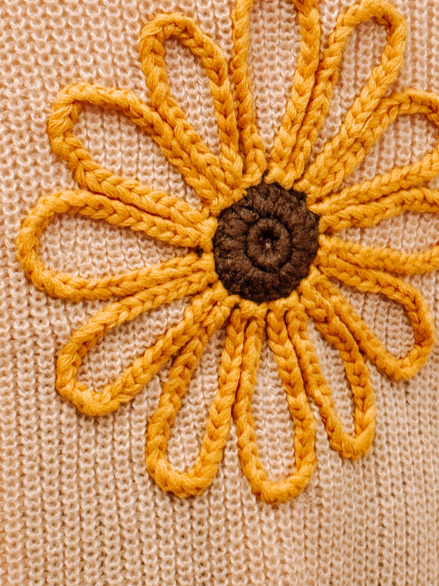 Peach knit sunflower cardigan.
